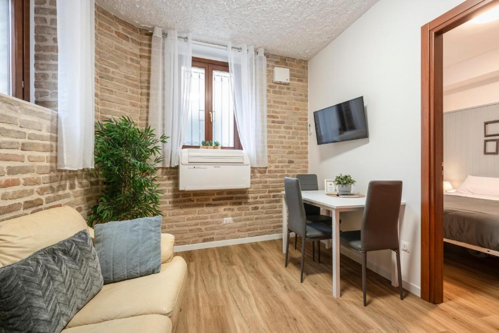 a living room with a couch and a table at Maison all'Arco in Corridonia
