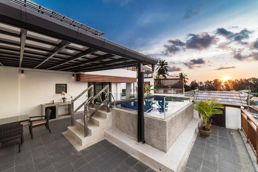 a house with a swimming pool on a patio at Surin Sabai Residence near Surin Beach in Surin Beach