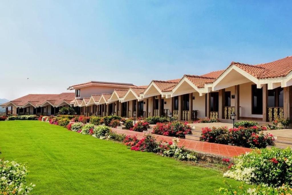 a row of houses with a green lawn at Summer Vines - Nashik in Pandhurli