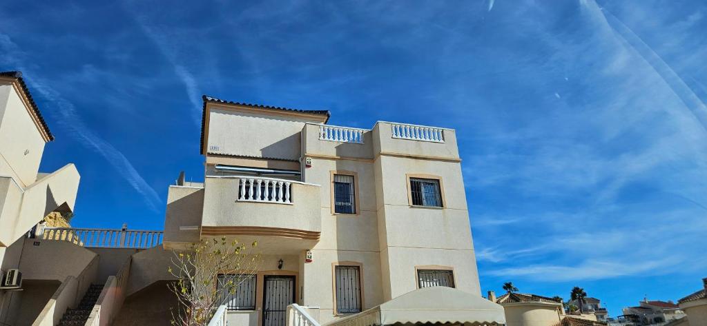 a large white building with a sky in the background at Sunny Hill Apartment in Ciudad Quesada
