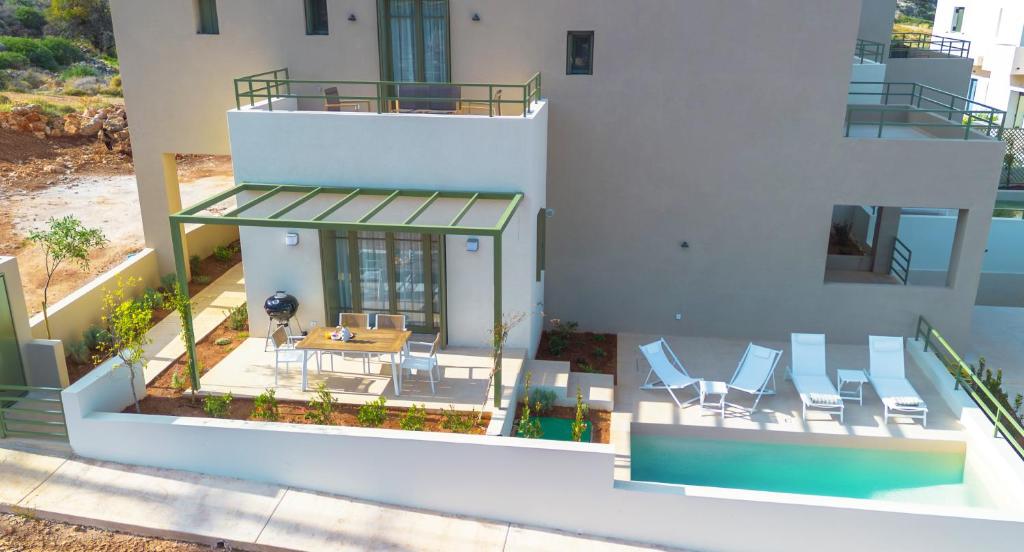 an aerial view of a house with chairs and a table at Villa Artemis 1 - Etheras Properties in Kythira