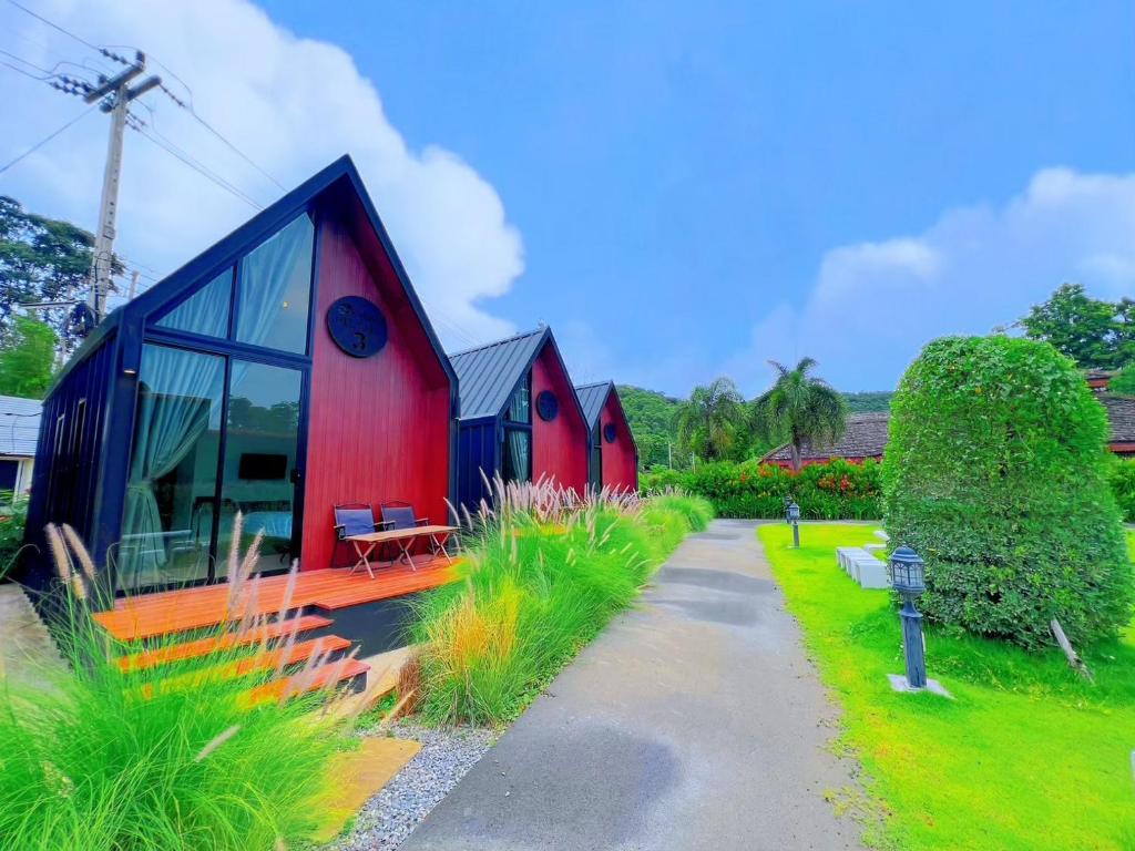 a red and blue house with a pathway at Nordic SkyBird Hill Chill in Pak Chong