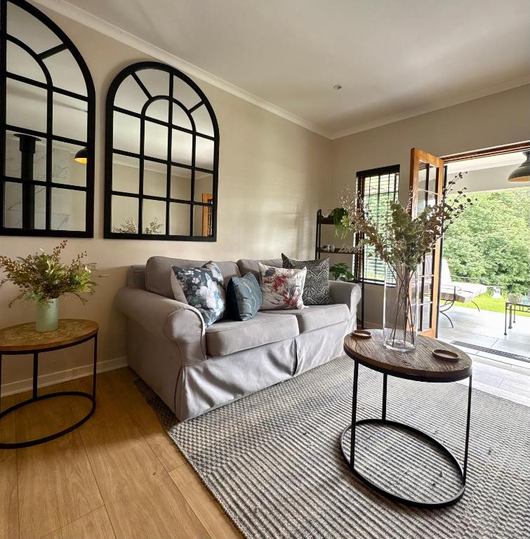 a living room with a couch and two tables at Hilton Guest House in Hilton