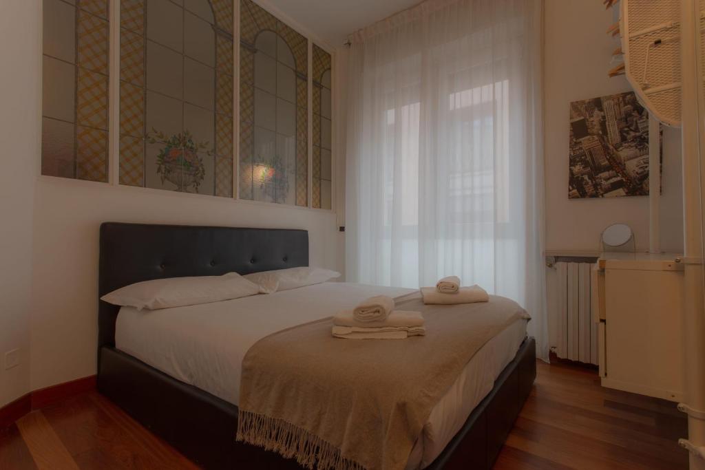a bedroom with a bed with two towels on it at Italianway Easy - Dogana 3 in Milan