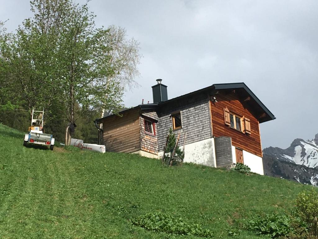 a house on top of a grassy hill at Chalet Valuga in Kaisers