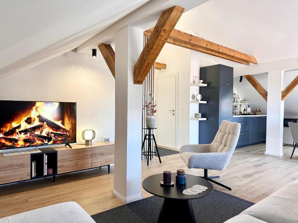 a living room with a fireplace and a couch at Apartman Romić in Vrlika