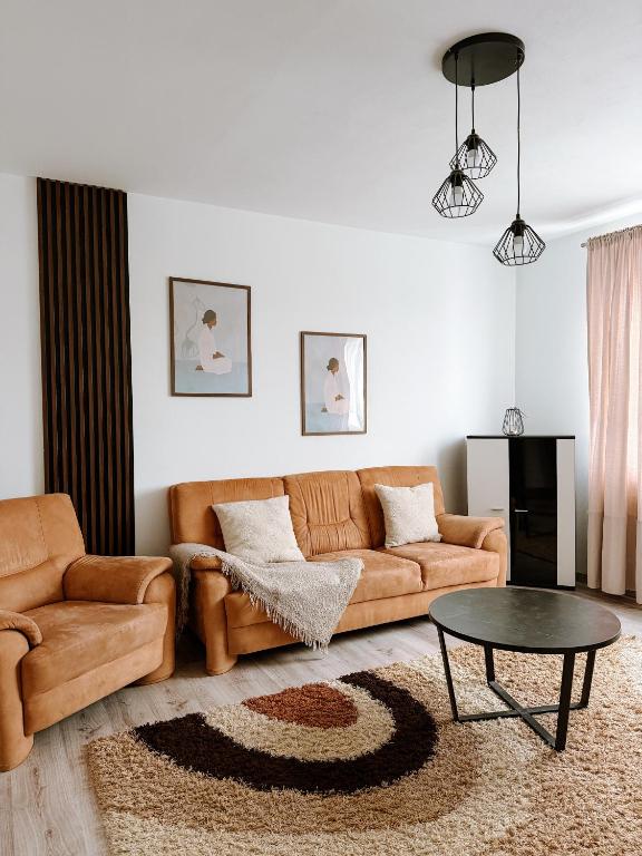 a living room with a couch and a table at Apartmán Mierová in Stará Ľubovňa