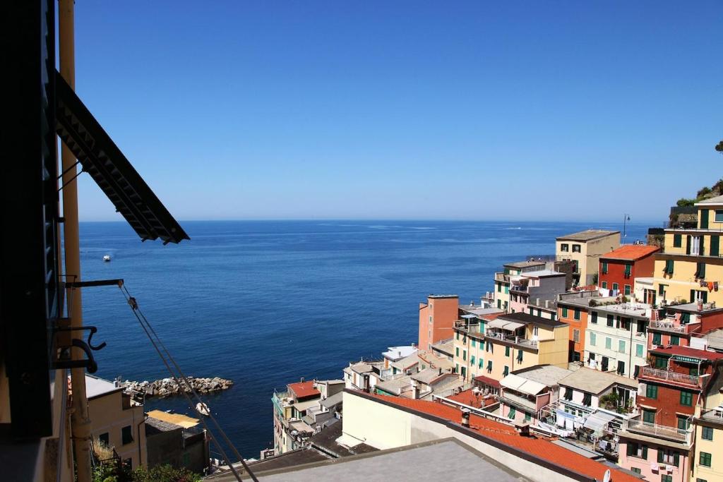 a view of the ocean from a city at Beautiful view apartment Riomaggiore, Cinque Terre in Riomaggiore