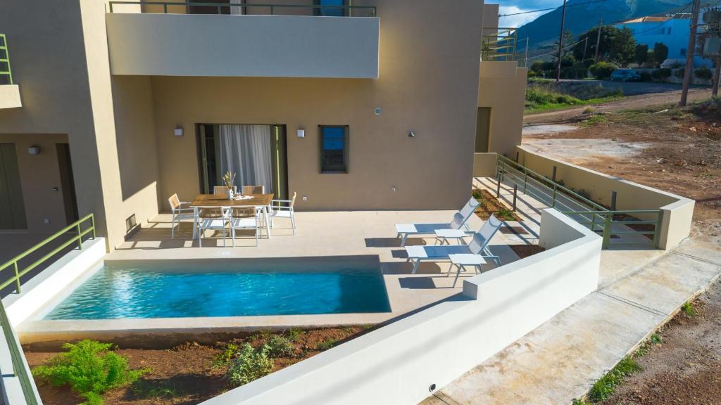 a house with a swimming pool and a table and chairs at Villa Artemis 4 - Etheras Properties in Kythira