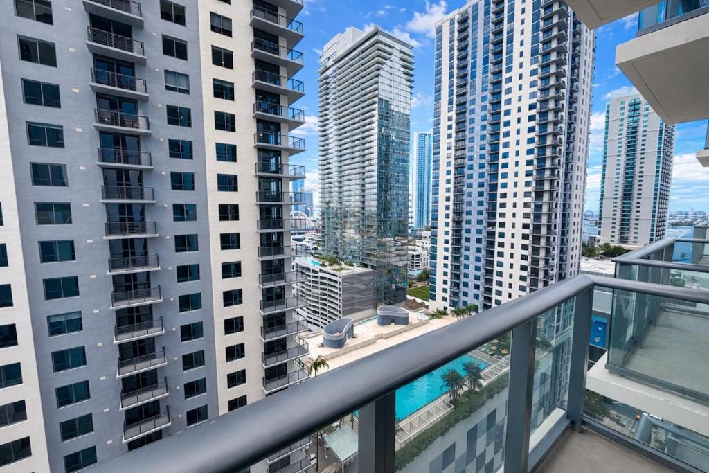 a balcony with a view of some tall buildings at Lujoso apartamento ,The Crosby Miami World Center in Miami