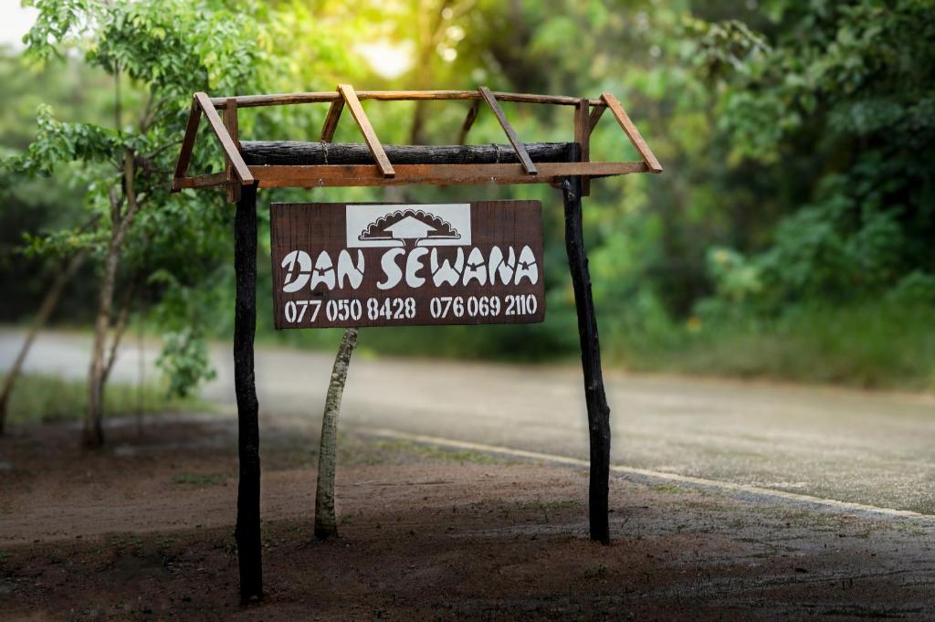 a sign on the side of a road at Dan Sewana in Nochchiyagama