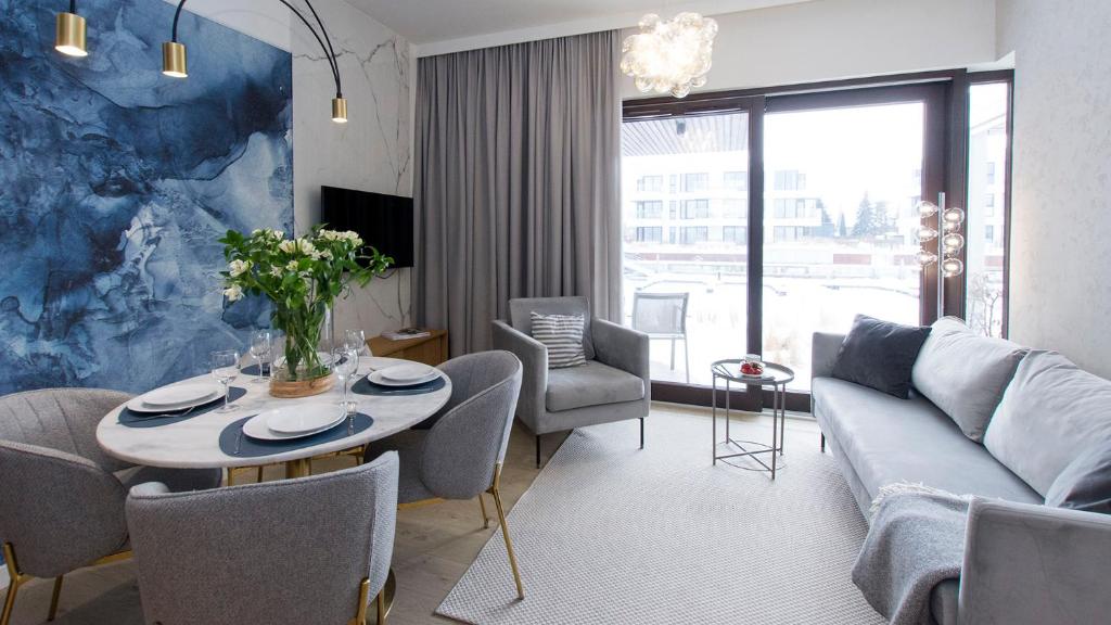 a living room with a couch and a table at Sol Marina 231 in Wiślinka