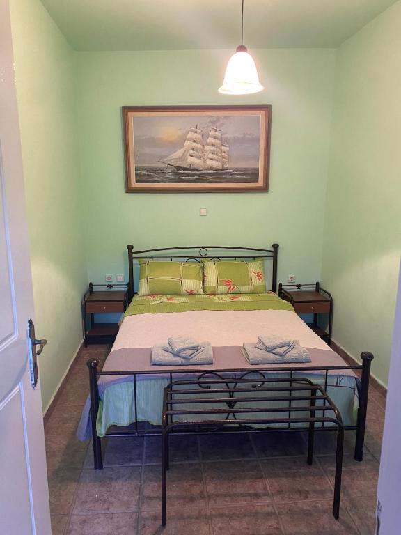 a bedroom with a bed with a picture on the wall at Mimi's House 2 in Véssa
