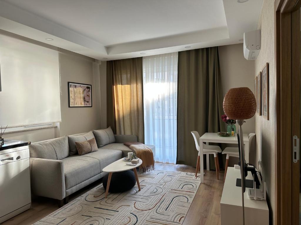 a living room with a couch and a table at Smartly Designed Cozy 1BR Apartment in Antalya