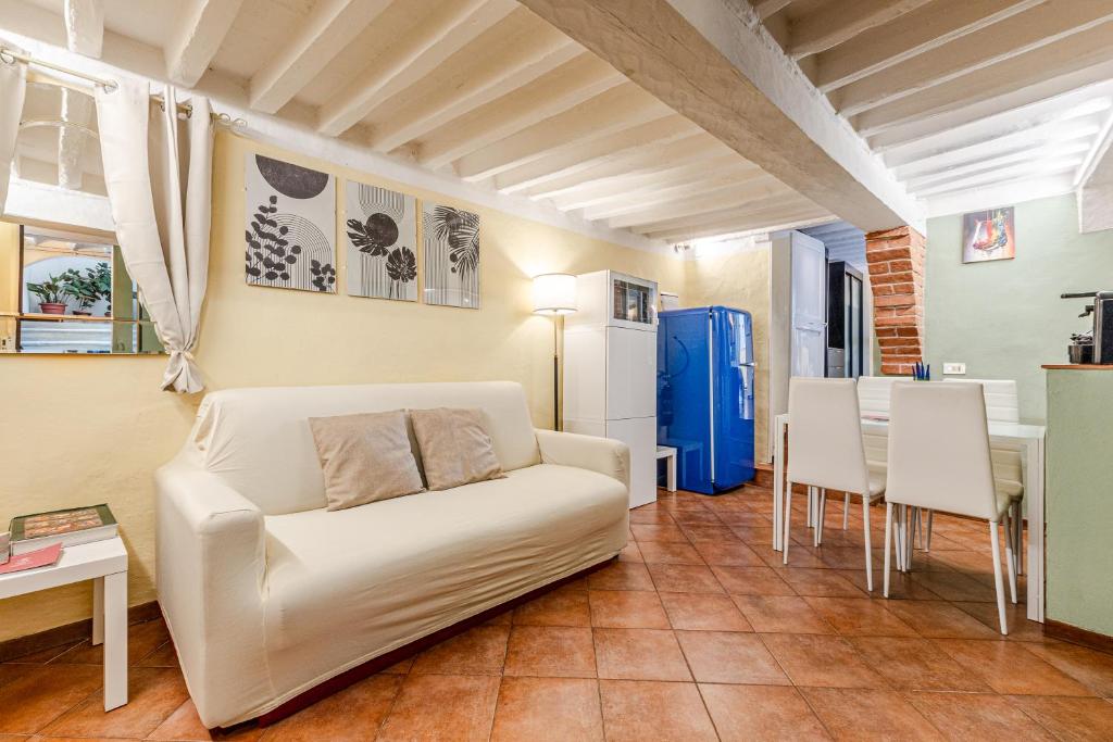a living room with a white couch and a table at Charming Mezzanino in Siena