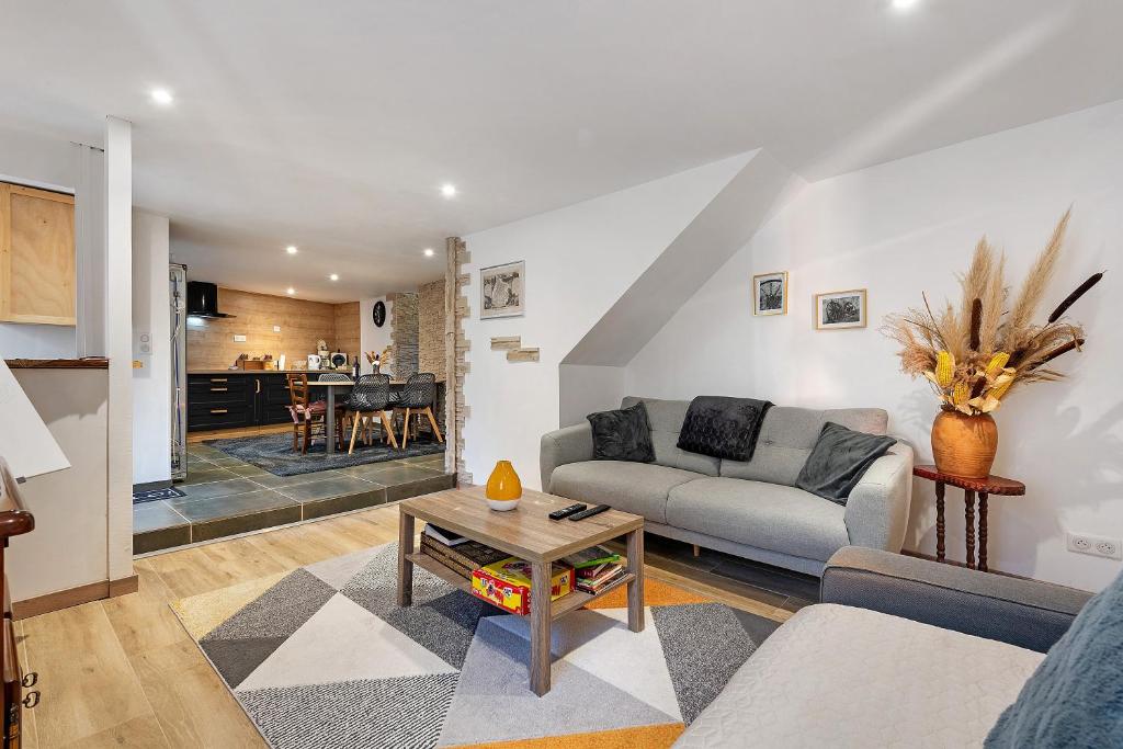 a living room with a couch and a table at Les Écrins de Campan in Campan