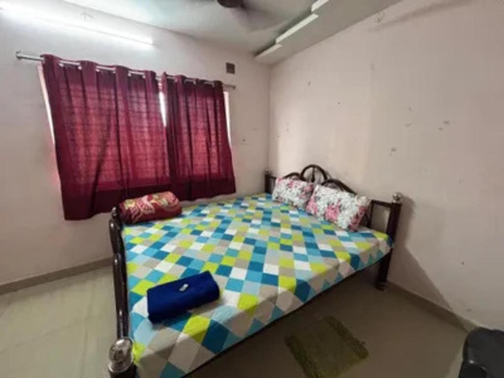 a bedroom with a bed in a room with a window at Via Ashiyana Inn in Kolkata