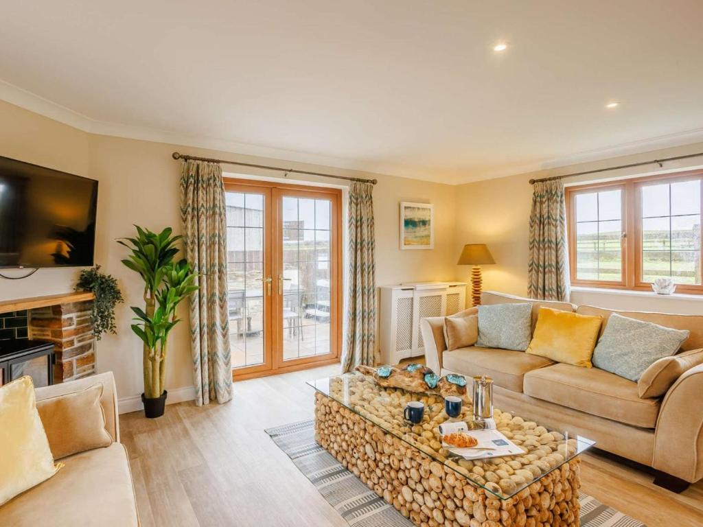 a living room with a couch and a coffee table at 3 Bed in Bideford oc-89865 in Westward Ho