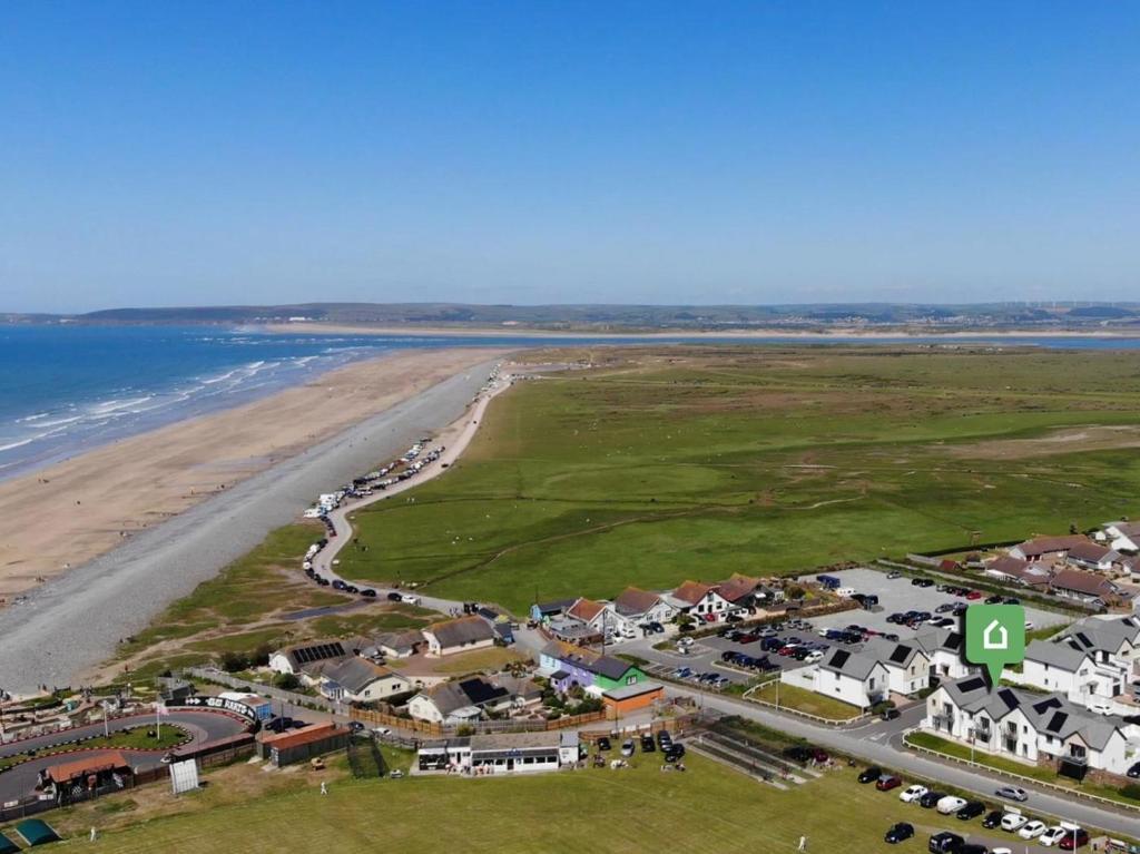 an aerial view of a beach next to the ocean at 3 Bed in Bideford oc-89018 in Westward Ho