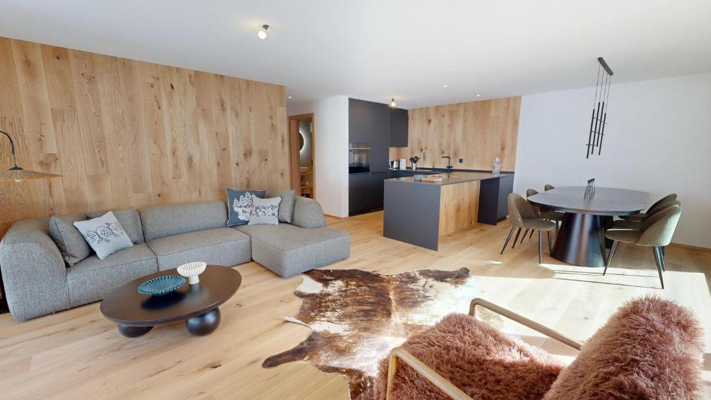 a living room with a couch and a table at Alphubel PEAK in Saas-Fee