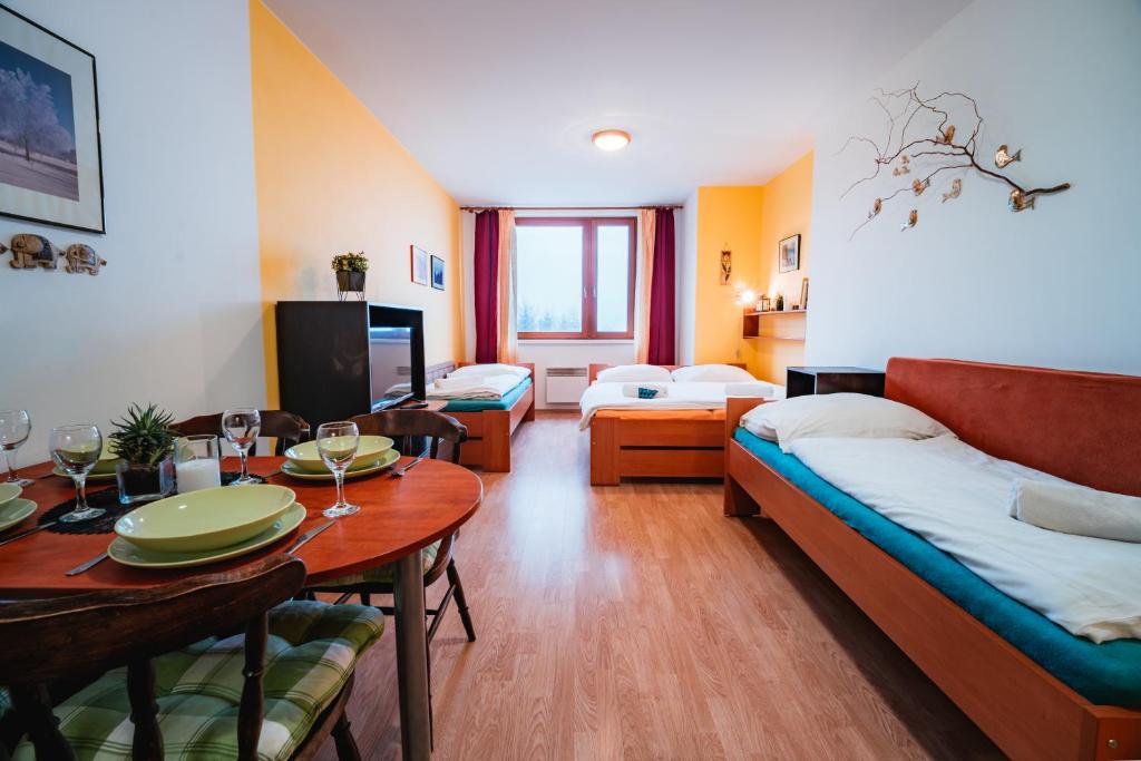 a living room with a couch and a table at Little Mountain Apartment in Ostružná