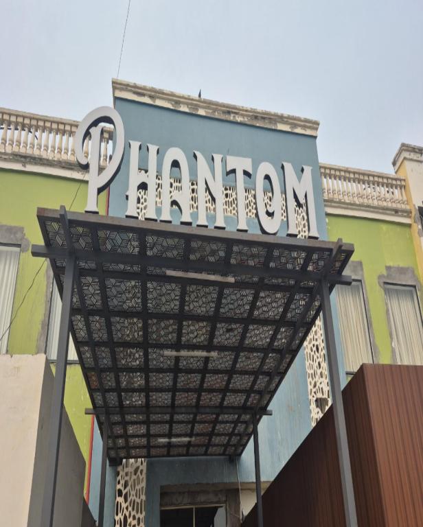 a sign for a pharmacy on top of a building at Hotel Phantom in Gangānagar