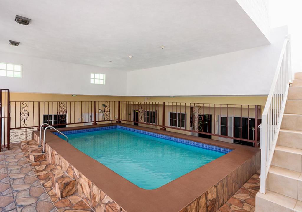 a large swimming pool in the middle of a building at Scarlett Near Cane River Falls in Bull Bay