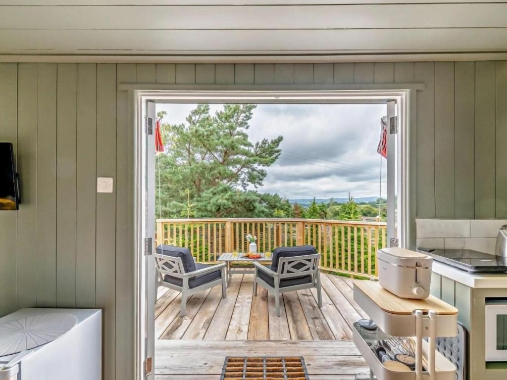 a screened in porch with a kitchen and a deck at 1 Bed in Paignton oc-93063 in Marldon