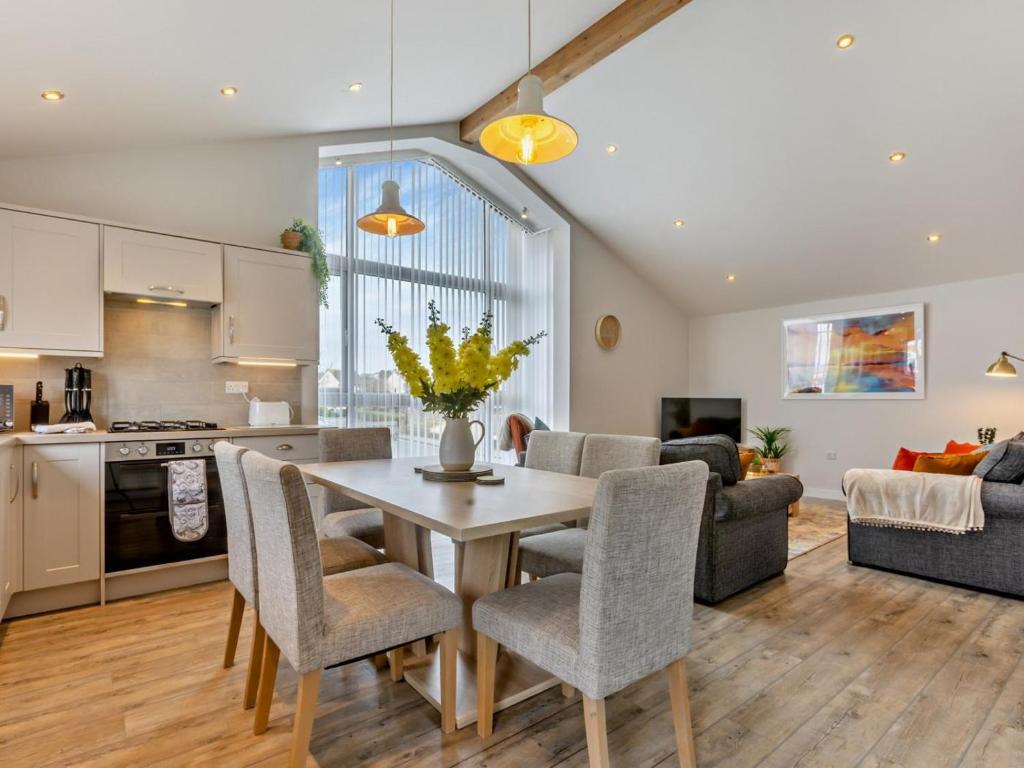 a kitchen and living room with a table and chairs at 3 Bed in Bideford oc-64410 in Northam