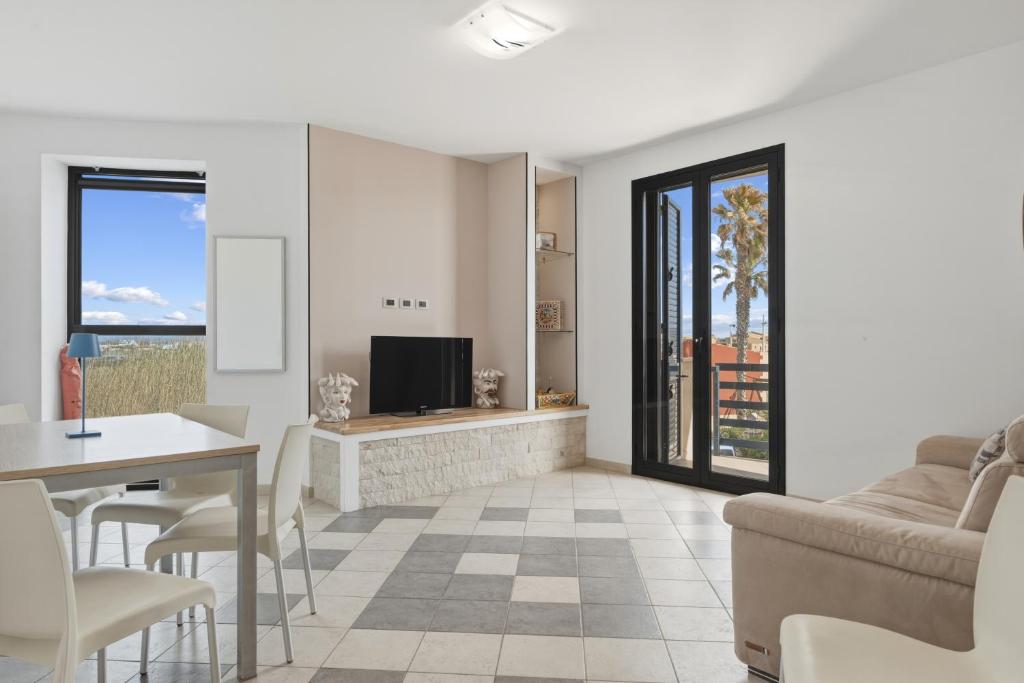 a living room with a couch and a table at Case Vacanze Celeste in Marzamemi