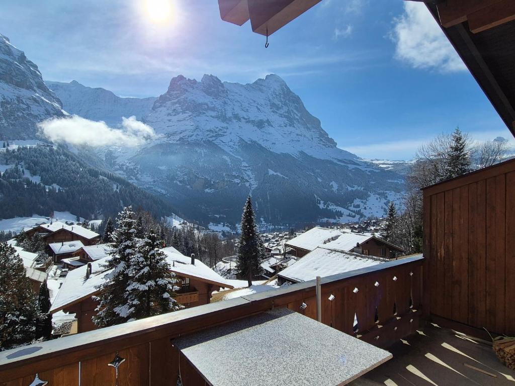 a balcony with a view of a snow covered mountain at ABO - Boutique Apartment - Chalet Horst in Grindelwald