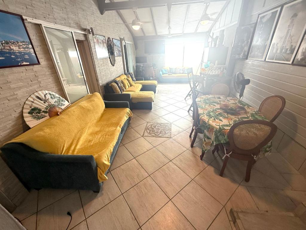 a living room with a couch and a table at residence caramboles in Fort-de-France