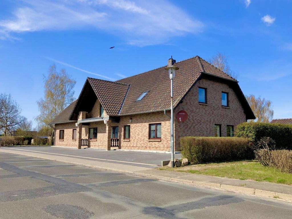a large brick house with a brown roof at FeWo Mäusehaus ID 16291-7 in Kargow