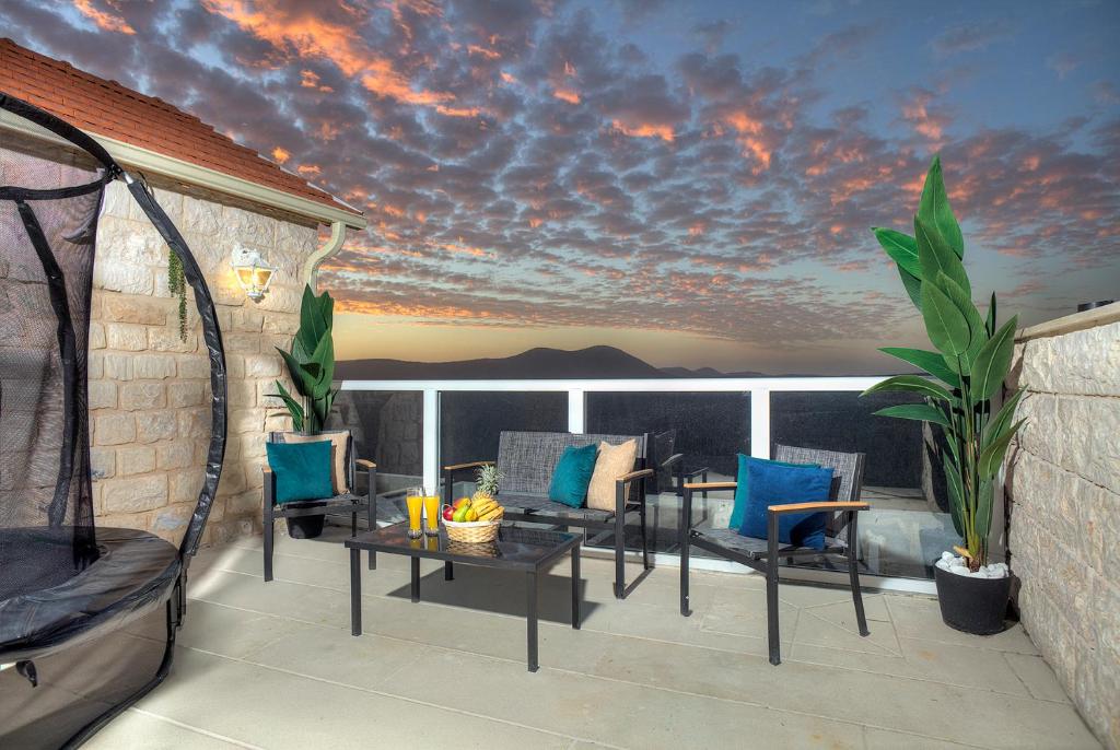 a patio with chairs and tables on a balcony at Mountain Top Views -205- נופי פסגות in Safed