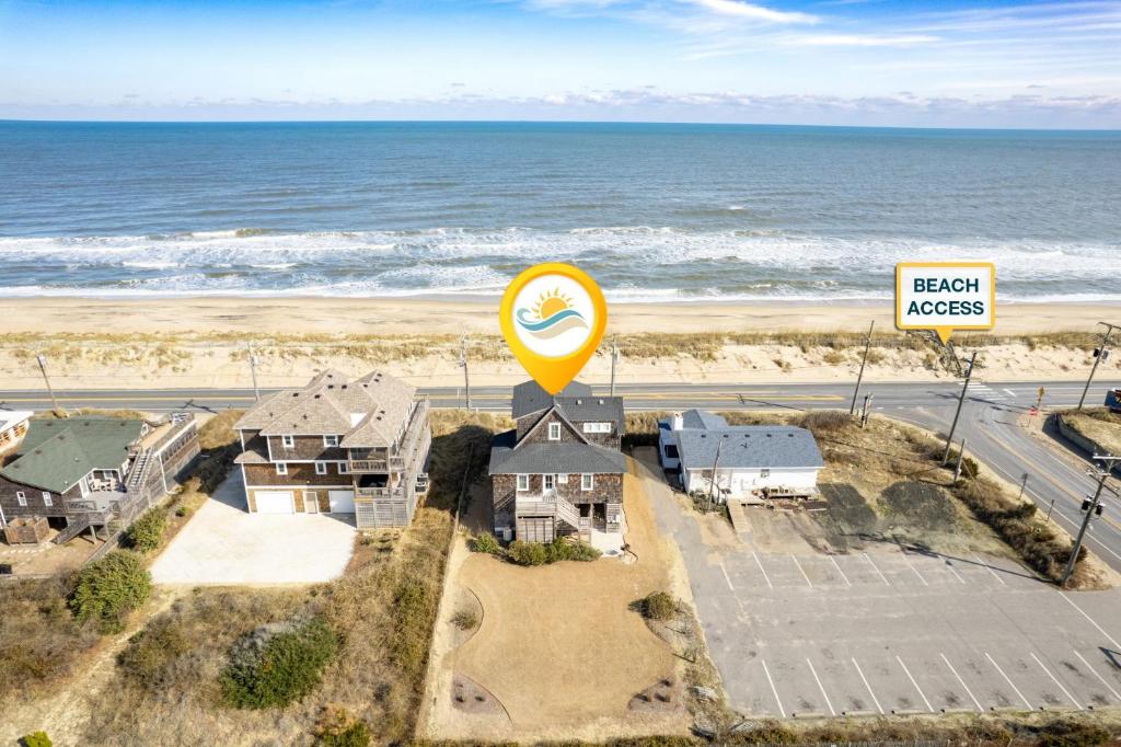 an aerial view of a beach access sign and the ocean at 4115 - Coastal Cottage in Kitty Hawk