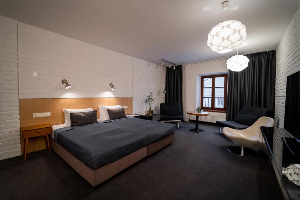 a bedroom with a bed and a desk and chairs at Trybunalska in Lublin