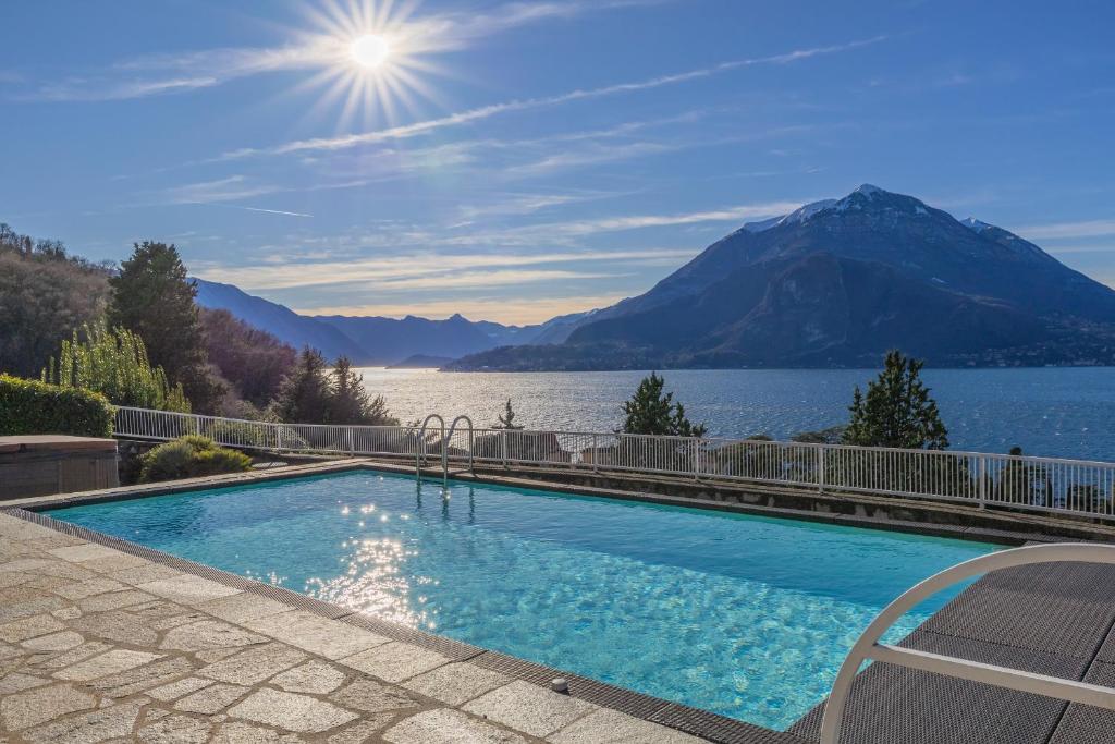 a swimming pool with a view of a lake and mountains at Villa La Perledina in Perledo