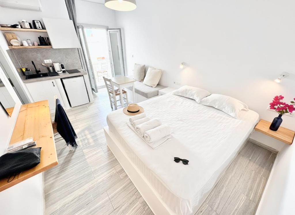 a bedroom with a large white bed in a room at Castellino Naxos in Naxos Chora