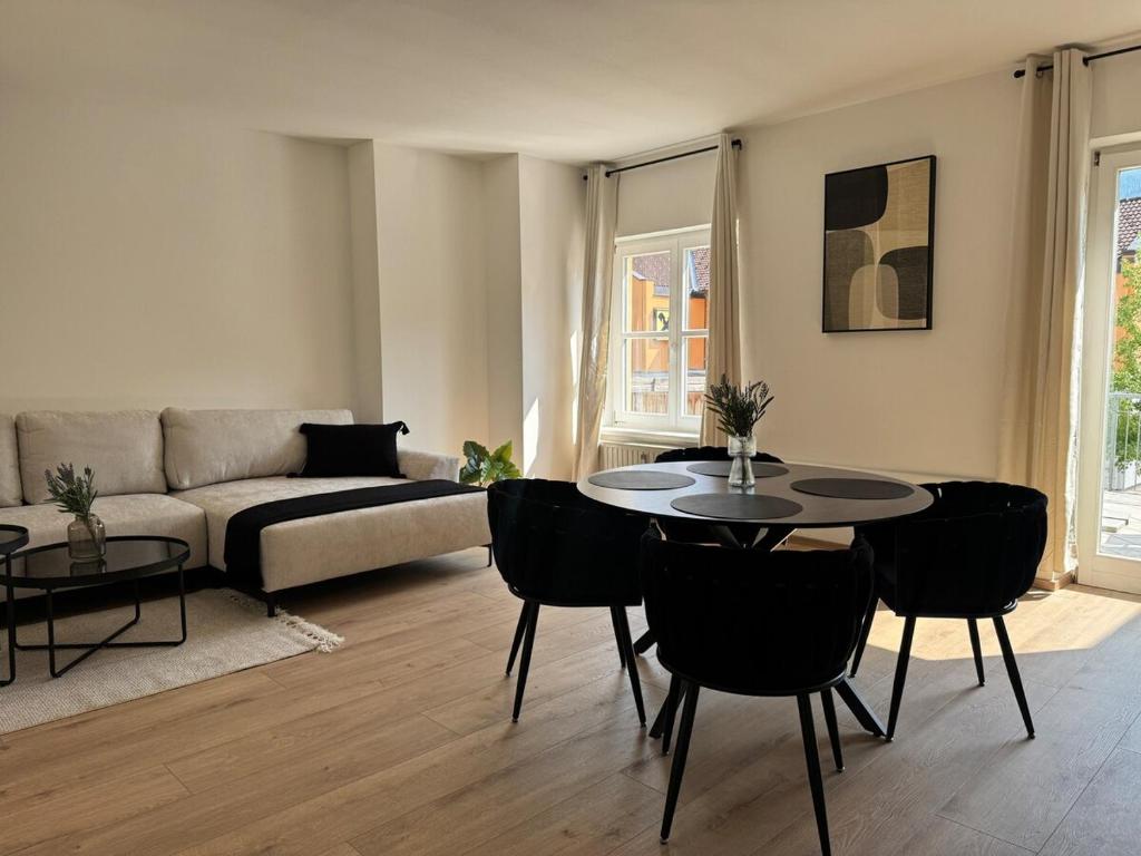 a living room with a couch and a table and chairs at Faraway Homes Studio Mautern #8 in Mautern in Steiermark