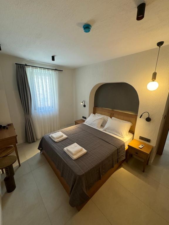 a bedroom with a bed with two towels on it at Ultava Koru Suites in Datca