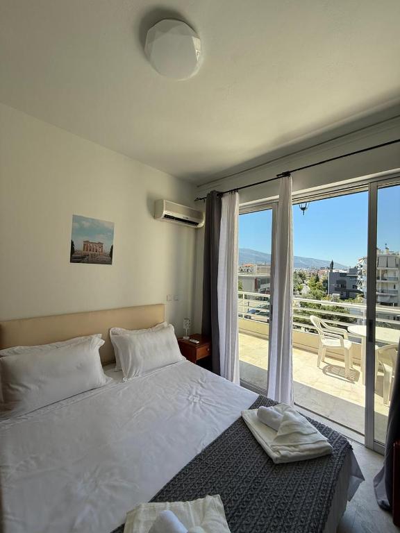 a bedroom with a bed and a large window at Escape at Chalandri Athens in Athens