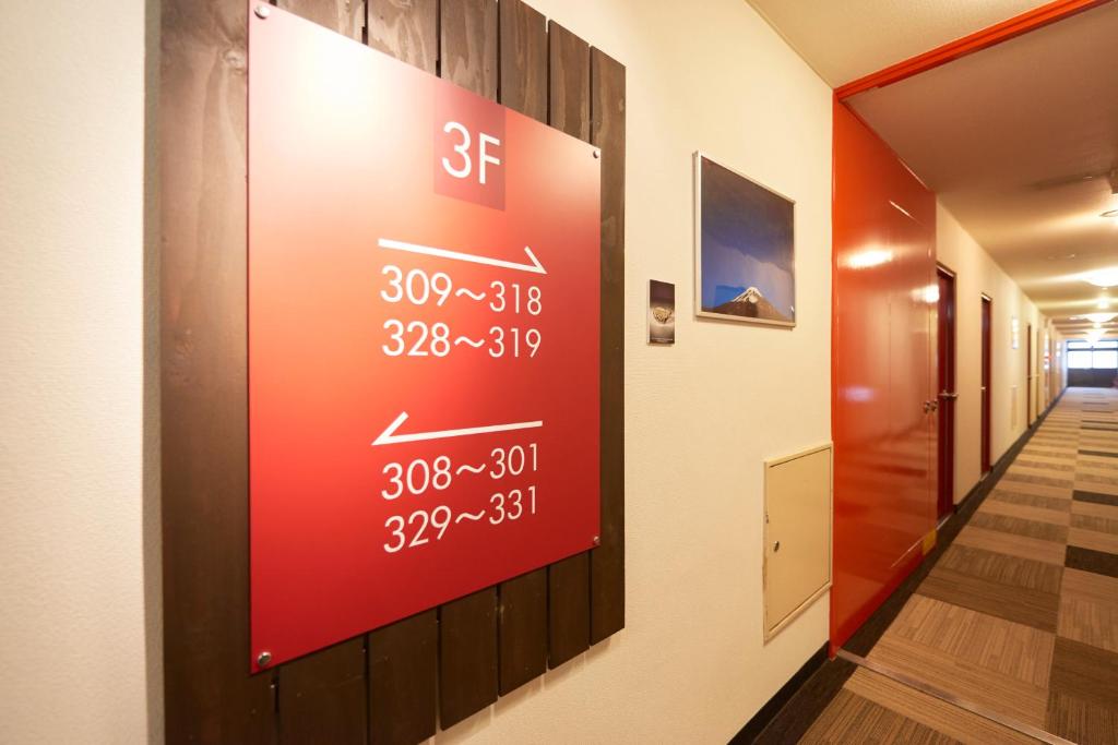 a sign on the wall of a hallway with a speedometer at Select Inn Fujisan Gotemba in Gotemba