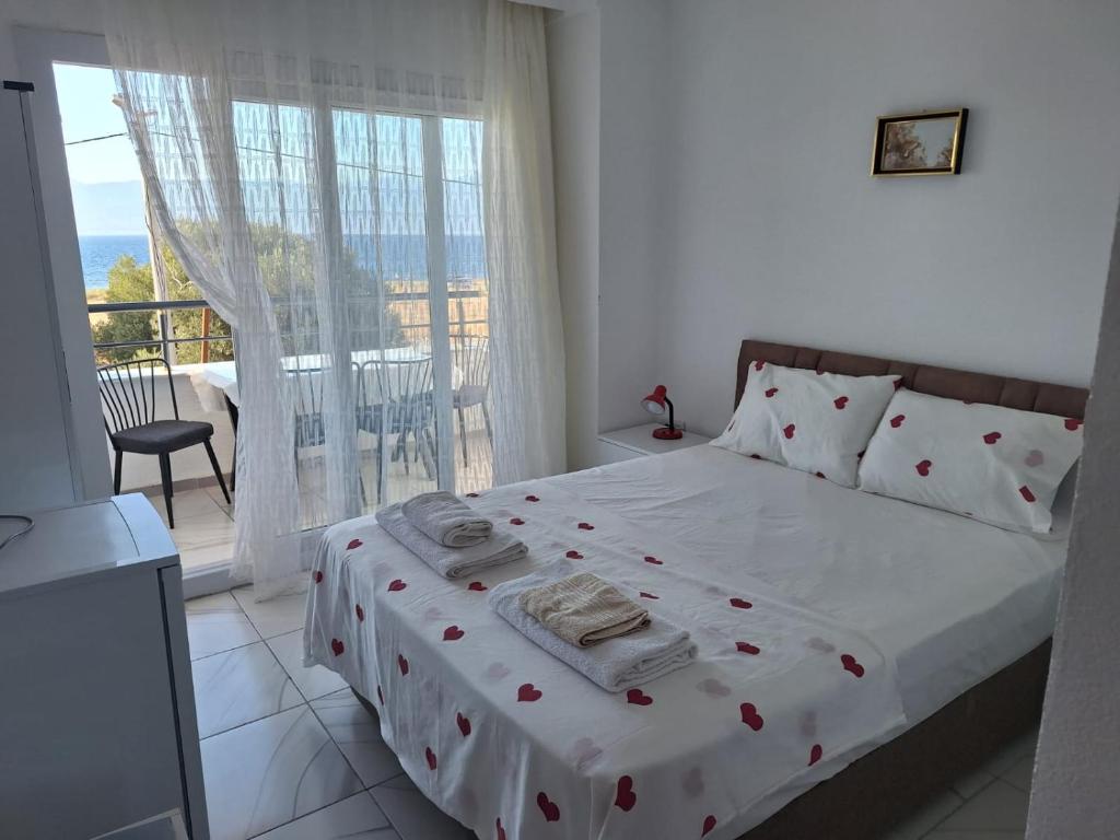 a bedroom with a bed and a balcony at Harmony Blue Pansiyon in Burhaniye