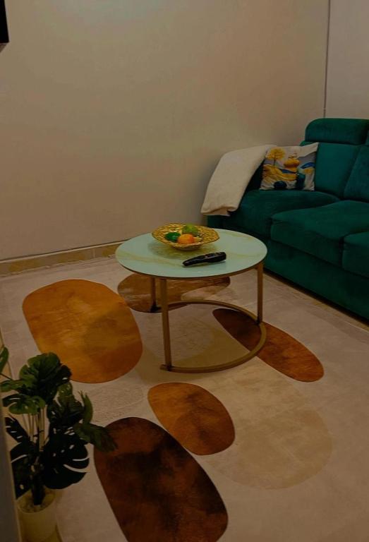 a living room with a table and a couch at Cozy Kipepeo Cottage in Nairobi