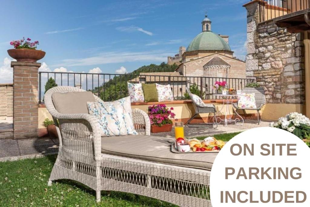 a wicker chair sitting on a patio with a table at Hotel Ideale in Assisi