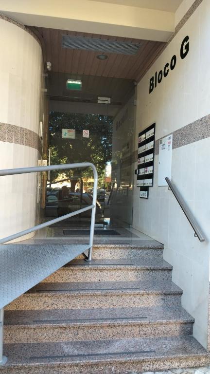a stairway leading into a building with a sign on it at Q1 Blueroom Sofia's Happy Apartment in Loulé
