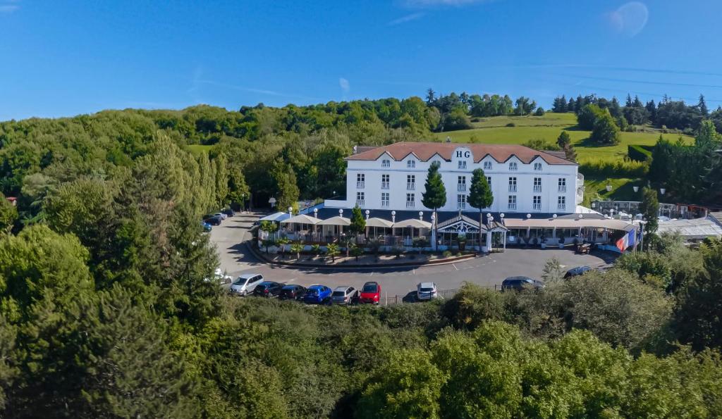 an aerial view of a large white building with a parking lot at Hotel Du Golf in Saint-Étienne