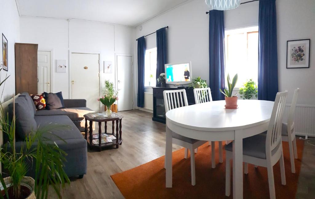 a living room with a table and a couch at Parkvillan Sunshine Living Condo in Koppom