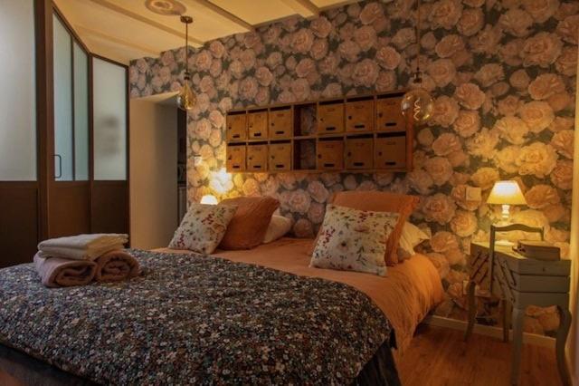 a bedroom with a large bed in a room at chez Thérèse in Auxonne