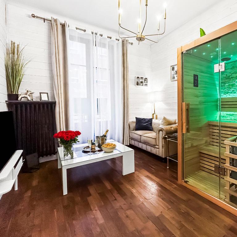 a living room with a couch and a table at Glamour & jacuzzi privé Chambéry in Chambéry